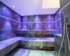 Nowoczesna sauna parowa z fioletowym oświetleniem.