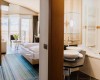 Nowoczesny pokój hotelowy z podwójnym łóżkiem i łazienką.