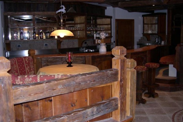 Nowoczesny pokój hotelowy z podwójnym łóżkiem, sofą i widokiem na góry.