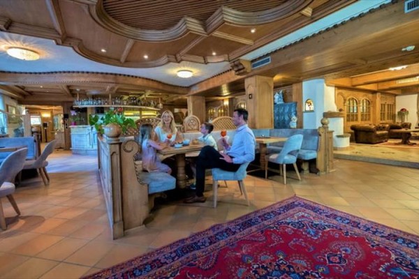 Rodzina siedzi przy stole w rustykalnej restauracji.