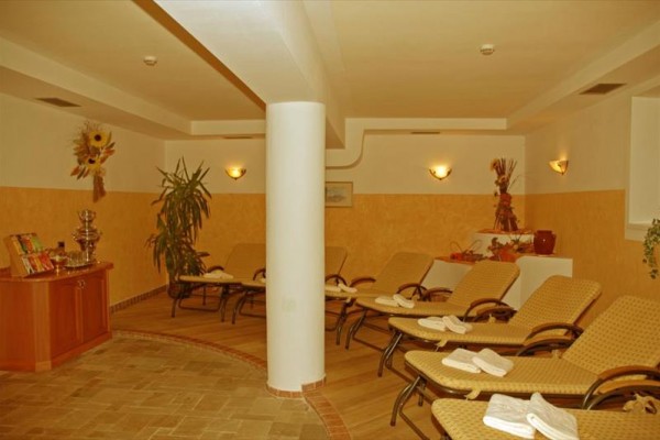 Nowoczesny pokój hotelowy z podwójnym łóżkiem, stołem i rośliną.
