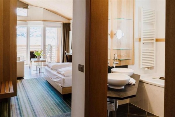 Nowoczesny pokój hotelowy z podwójnym łóżkiem i łazienką.
