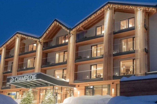 Hotel w wieczornym oświetleniu z zaśnieżonym krajobrazem.